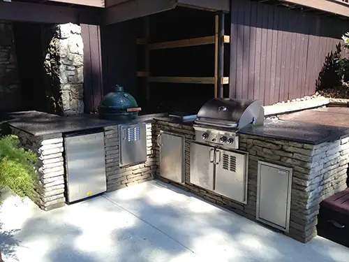 A beautiful outdoor kitchen with a grill