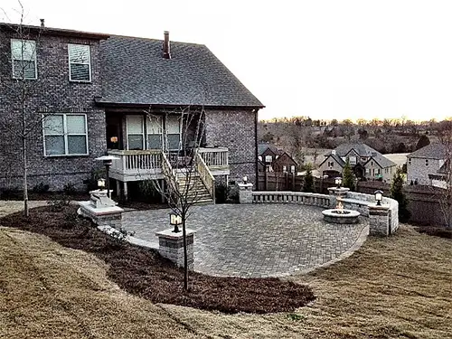 An outdoor fire pit surrounded by lighting